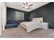 This modern bedroom features a ceiling fan, window with blinds, carpet flooring, and a relaxing chair for comfort at 25127 E Maple Ave, Aurora, CO 80018