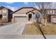 Charming single-Gathering home featuring a two-car garage and stone accents on a well-maintained lawn at 25127 E Maple Ave, Aurora, CO 80018