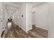 Bright hallway with wood floors leading to rooms and dining area offering a blend of functionality and style at 25127 E Maple Ave, Aurora, CO 80018
