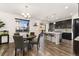 Bright kitchen and dining area featuring a breakfast bar, stainless appliances and access to the backyard at 25127 E Maple Ave, Aurora, CO 80018