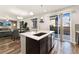 Open-concept kitchen area with island, stainless steel appliances, and connection to the living room at 25127 E Maple Ave, Aurora, CO 80018