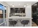 Kitchen island with stainless steel sink, quartz countertops, and seating, with access to outdoor space at 25127 E Maple Ave, Aurora, CO 80018