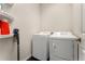 Well-equipped laundry room with modern washer and dryer, and convenient shelving for storage, offering efficiency at 25127 E Maple Ave, Aurora, CO 80018
