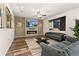 Elegant living room with a fireplace, modern lighting, and a large window providing natural light at 25127 E Maple Ave, Aurora, CO 80018