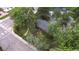 Aerial shot displays the roof of the cozy home and surrounding yard with mature trees at 1703 W Weaver Ave, Littleton, CO 80120