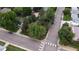 Bird's-eye view of the house located on a residential street surrounded by mature trees at 1703 W Weaver Ave, Littleton, CO 80120
