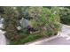 An aerial view of the cozy home nestled among mature trees on a residential street at 1703 W Weaver Ave, Littleton, CO 80120