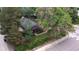 An aerial view of the cozy home surrounded by mature trees and a neatly kept yard at 1703 W Weaver Ave, Littleton, CO 80120
