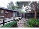A fenced backyard with a wooden deck, rock detail and easy access through a side gate at 1703 W Weaver Ave, Littleton, CO 80120