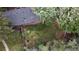 Aerial view of a backyard with mature trees, a fence, and gravel area at 1703 W Weaver Ave, Littleton, CO 80120
