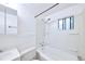 Bright bathroom featuring a tub/shower combination and a window for natural light and ventilation at 1703 W Weaver Ave, Littleton, CO 80120
