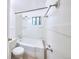 Bright bathroom featuring a tub/shower combination and a window for natural light and ventilation at 1703 W Weaver Ave, Littleton, CO 80120