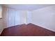 Comfortable bedroom featuring wood-look floors, closet space, and a large window for natural light at 1703 W Weaver Ave, Littleton, CO 80120