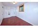 Spacious bedroom featuring wood-look floors, closet space, and a window for natural light and ventilation at 1703 W Weaver Ave, Littleton, CO 80120