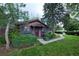 Charming home featuring a well-manicured lawn and mature trees enhancing the curb appeal at 1703 W Weaver Ave, Littleton, CO 80120