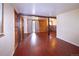 Spacious living room featuring modern wood-look floors, and access to the backyard through glass doors at 1703 W Weaver Ave, Littleton, CO 80120