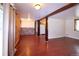 Open-concept living room with backyard access, wood-look floors, and natural light, with an adjacent kitchen at 1703 W Weaver Ave, Littleton, CO 80120