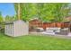 Beautiful backyard featuring a shed, outdoor seating with a fire pit, and a well-manicured lawn at 503 Lois Dr, Louisville, CO 80027