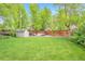 Expansive backyard with lush green grass, a storage shed, and an inviting outdoor seating area at 503 Lois Dr, Louisville, CO 80027
