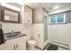 Charming bathroom with wainscoting, tiled floors, a modern vanity and walk-in shower at 503 Lois Dr, Louisville, CO 80027