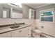 Updated bathroom with modern vanity, a large mirror, and a window providing natural light at 503 Lois Dr, Louisville, CO 80027
