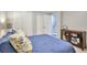 Comfortable bedroom featuring a cozy bed with a blue comforter, and a cabinet to the side at 503 Lois Dr, Louisville, CO 80027