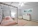 Cozy bedroom with a four-poster bed, plush rug, and a window offering natural light at 503 Lois Dr, Louisville, CO 80027
