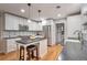 Bright kitchen featuring white cabinets, stainless steel appliances, and an island with barstool seating at 503 Lois Dr, Louisville, CO 80027