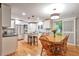 Open kitchen and dining area featuring stainless steel appliances, a large island, and modern lighting fixtures at 503 Lois Dr, Louisville, CO 80027