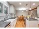 Bright, eat-in kitchen features white cabinets, stainless steel appliances, and hardwood floors at 503 Lois Dr, Louisville, CO 80027