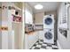 Well-organized laundry room with stacked washer and dryer, ample shelving, and a convenient countertop at 503 Lois Dr, Louisville, CO 80027