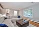 Bright living room with a large bay window, hardwood floors, and comfortable seating arrangement at 503 Lois Dr, Louisville, CO 80027