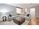 Spacious living room featuring hardwood floors, comfortable sectional sofa, and a leather ottoman at 503 Lois Dr, Louisville, CO 80027