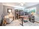 Well-lit home office with modern decor, built-in shelving, and a comfortable seating area at 503 Lois Dr, Louisville, CO 80027