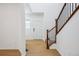 Bright entryway with hardwood floors and staircase with metal railing at 2068 Chambers Rd, Brighton, CO 80601