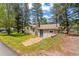 View of the front exterior featuring a charming home with a stone chimney and blue front door at 26351 Sheldon St, Kittredge, CO 80457