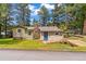 Charming single Gathering home featuring a stone chimney, blue front door, and wooden walkway at 26351 Sheldon St, Kittredge, CO 80457