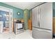 Updated kitchen features stainless steel appliances, blue walls, and a view into an adjacent bath at 26351 Sheldon St, Kittredge, CO 80457
