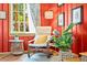 Cozy living room features a comfortable rocking chair, natural light, and a decorative house plant at 26351 Sheldon St, Kittredge, CO 80457