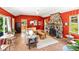 Open-concept living room with wood floors, stone fireplace, and bright-colored walls at 26351 Sheldon St, Kittredge, CO 80457
