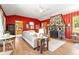 Spacious living room featuring wood floors, a stone fireplace, and bright-colored walls at 26351 Sheldon St, Kittredge, CO 80457