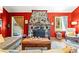 Living room featuring a stone fireplace, wood flooring, and bright-colored walls at 26351 Sheldon St, Kittredge, CO 80457