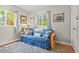 Living room with futon, area rug, and picture windows with green outdoor views at 26351 Sheldon St, Kittredge, CO 80457