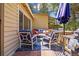 Comfortable patio furniture on a wooden deck, perfect for outdoor relaxation and entertaining in this lovely home at 26351 Sheldon St, Kittredge, CO 80457