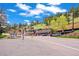 A vibrant street view showing the local merchants area with beautiful mountain views under a blue sky at 26351 Sheldon St, Kittredge, CO 80457