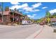 A view of a busy street with rustic buildings showcasing local shops under a beautiful sky with mountain views at 26351 Sheldon St, Kittredge, CO 80457