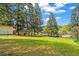 Picturesque backyard surrounded by lush trees, showcasing the serene and private setting of this beautiful home at 26351 Sheldon St, Kittredge, CO 80457