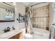Well-lit bathroom with a shower-tub combo, decorative shower curtain, and a modern vanity at 15373 Uravan St, Brighton, CO 80601