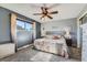 Cozy bedroom with a ceiling fan, a large window, and neutral decor to enhance a relaxing atmosphere at 15373 Uravan St, Brighton, CO 80601