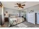 Bright bedroom featuring a ceiling fan, a dresser with mirror, and neutral decor for a relaxing atmosphere at 15373 Uravan St, Brighton, CO 80601